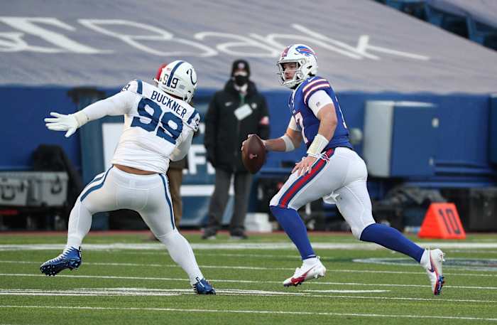 Buffalo Bills quarterback Josh Allen scrambles away from Indianapolis Colts defensive tackle DeForest Buckner in an AFC Wild Card Playoff home win.
